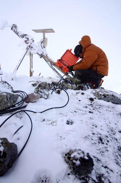 Person works on instrument in cold weather.