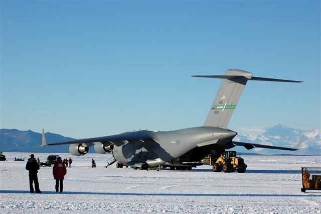 Large plane sits on ice field.