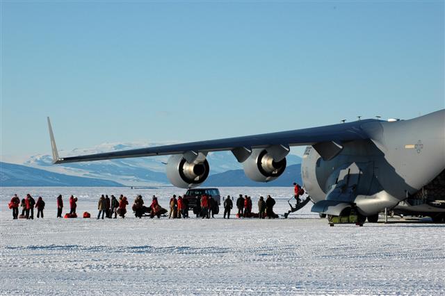 People get off of an airplane onto ice.