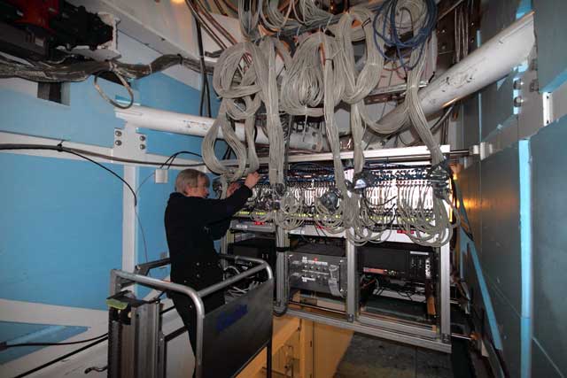 Person works on electronics system.