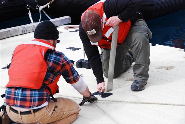 People work on a deck. 