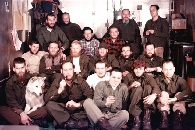 Group photo of men with a dog.