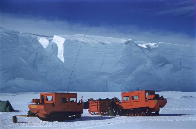 Vehicles sit on ice.