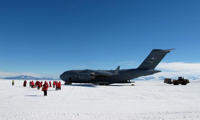 People depart plane on ice.