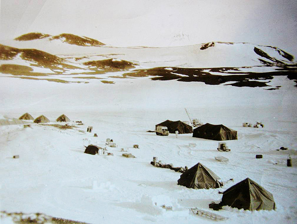 Old photo of tents on snow.