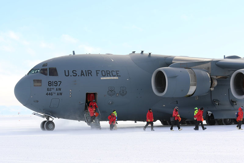 The first C-17 of the summer season delivers researchers and support staff to McMurdo Station after a two-week weather delay