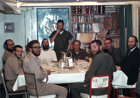 Men sit around a dining table.
