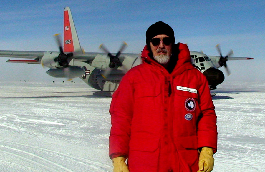 Charles Bentley stands in front of an LC-130 after arriving at the West Antarctic Ice Sheet drilling camp