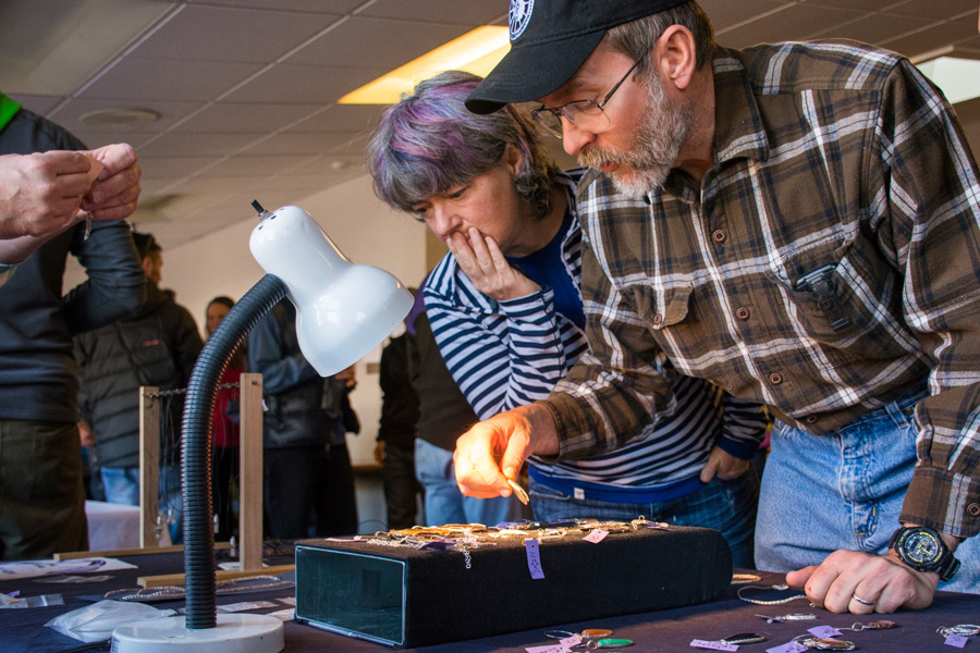 Sandra and John Loomis admire some of Harry Fishel’s necklaces he creates while teaching his jewelry making class.