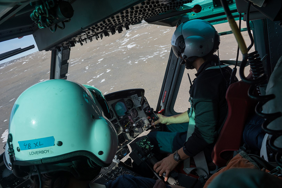 Mike Tinervia (right) pilots a Bell 212 helicopter over the McMurdo Dry Valleys with Mike Jansen