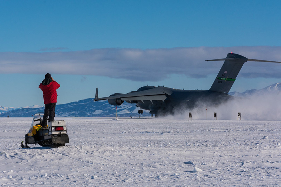 George Blaisdell watches from his snowmobile as a C-17 takes off from the new Phoenix Airfield