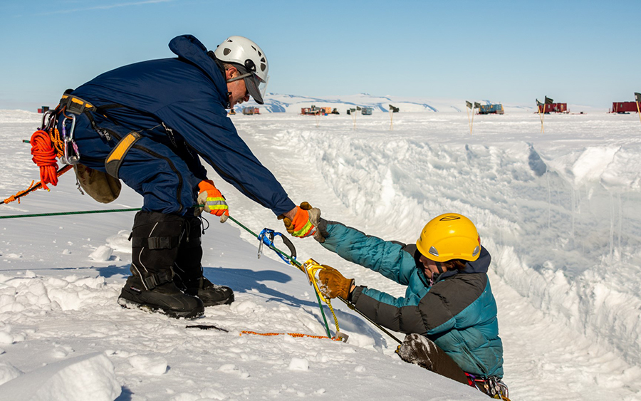Search and Rescue supervisor John Loomis helps SAR team member Christina Bovinette out of a simulated crevasse during a training simulation.
