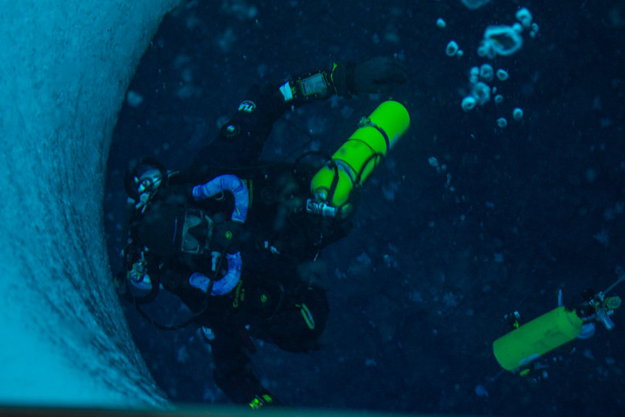 Diver Steve Rupp looks up from under the sea ice while testing one of the rebreather systems.