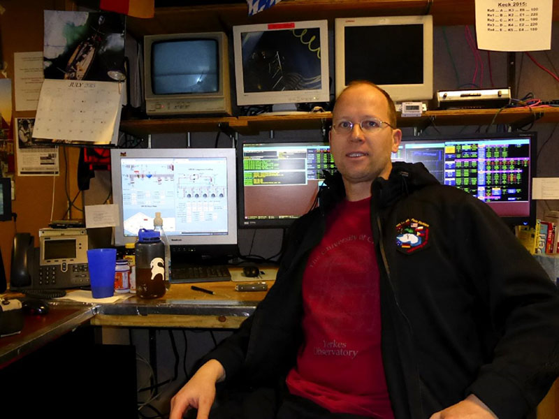 Robert Schwarz sits in front of the controls to the Keck Array
