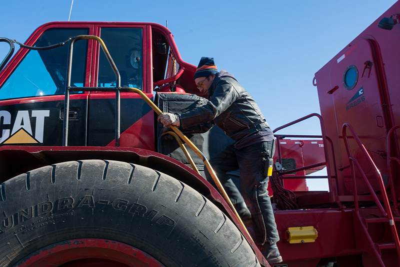 Driver Manuel Garcia climbs into the driver’s seat of the enormous Kress, one of the vehicles specially outfitted for driving passengers around McMurdo Station
