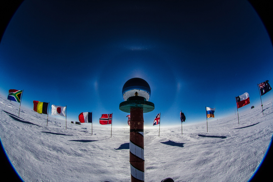 The flags of the original 12 signatory nations to the Antarctic Treaty surround the ceremonial South Pole