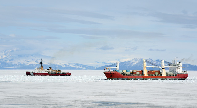 Two ships sail in icy waters.