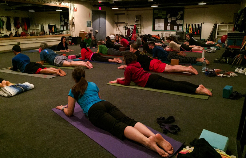 A full class of yoga participants fill the fitness room in McMurdo