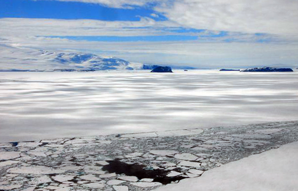 Channel of broken ice and mountains.