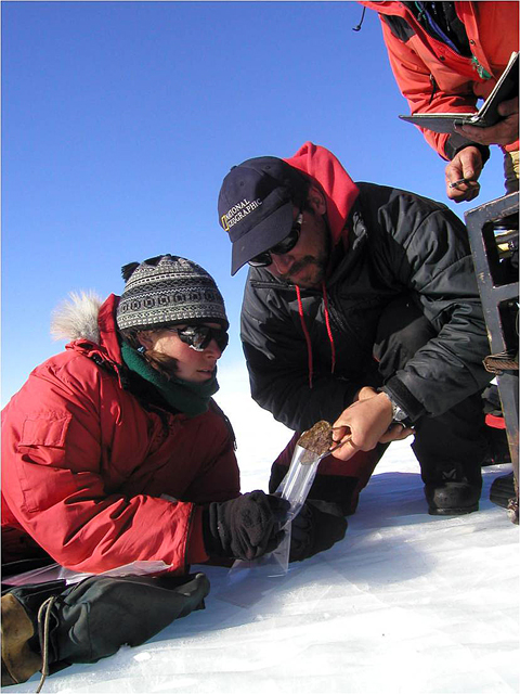 Field team members collect a space rock.