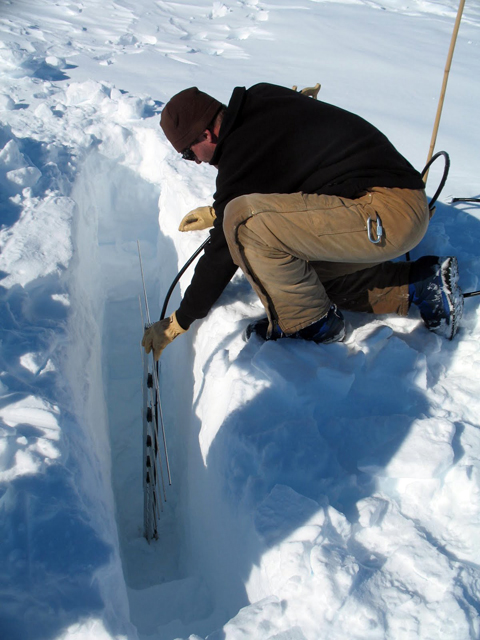 A scientist puts gear into the ice.