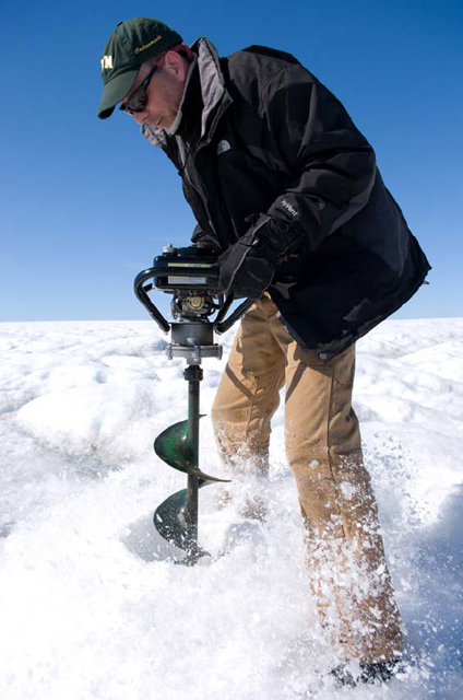 Ian Joughin drills a hole in the Greenland ice sheet.