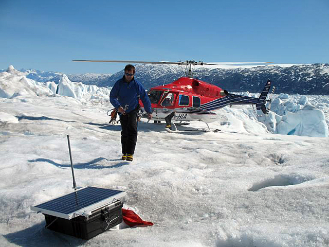Max exits helicopter on ice.