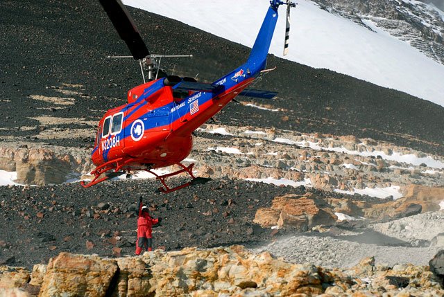 Person attaches something to helicopter.