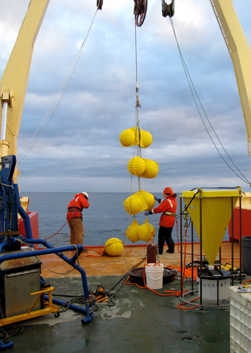 Scientists deploy sediment traps from a ship.