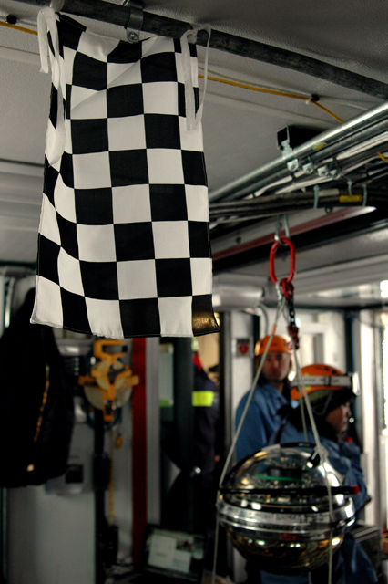 Checkered flag hangs in a room.