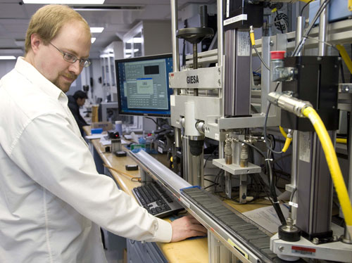 A scientist works on a sediment core in a lab.