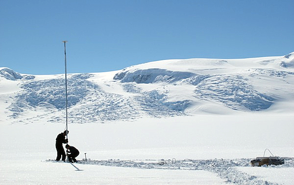 Scientists set up instrument on ice.