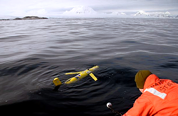 Scientists release instrument into the water.