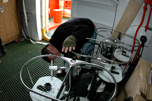 Scientist checks on instrument.