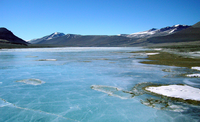 Frozen lake in valley.