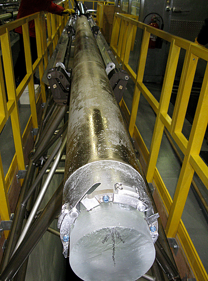 Head of ice core poking out of drill barrel.