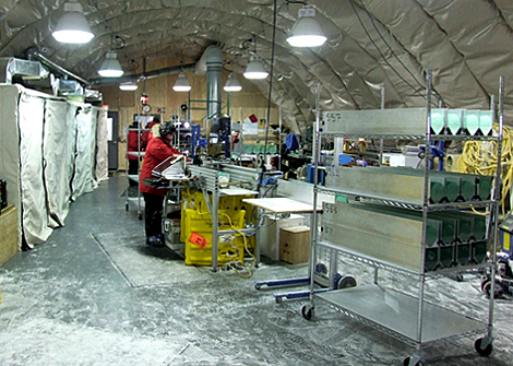 Long room with people working on ice.