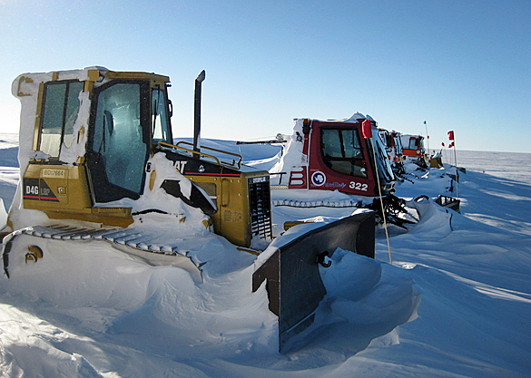 Tractors buried in snow.