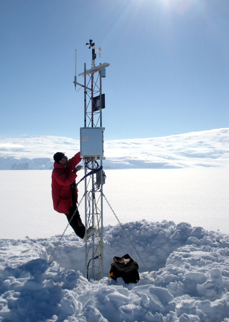 Scientist climbs on a weather station.