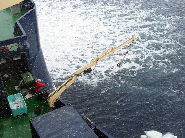 Ship crane aboard ship in bad weather.