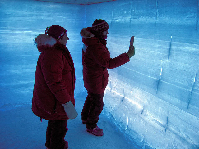 People examine wall of snow pit.
