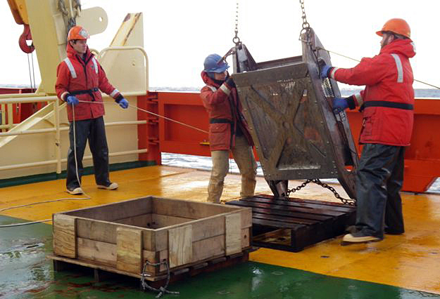 People work on the deck of a ship.