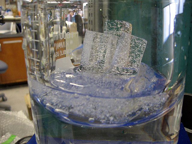 Ice melts in a container.