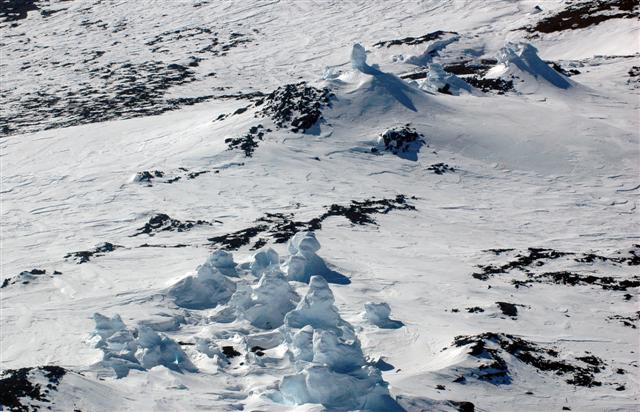 Ice towers on snow field.