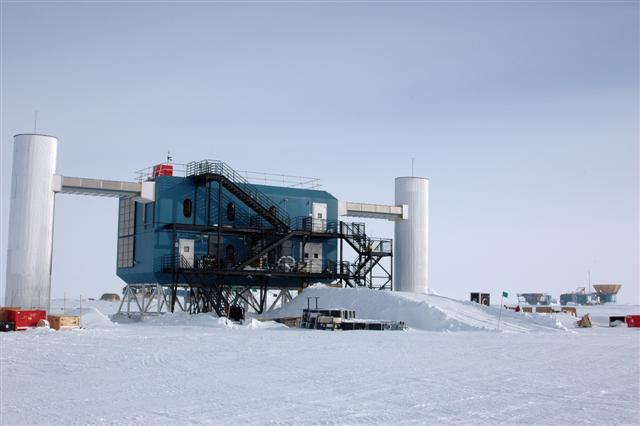 Blue building with two silver towers sits on snow.