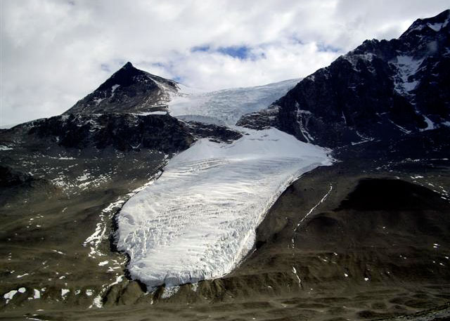Glaciers slides down mountainside. 