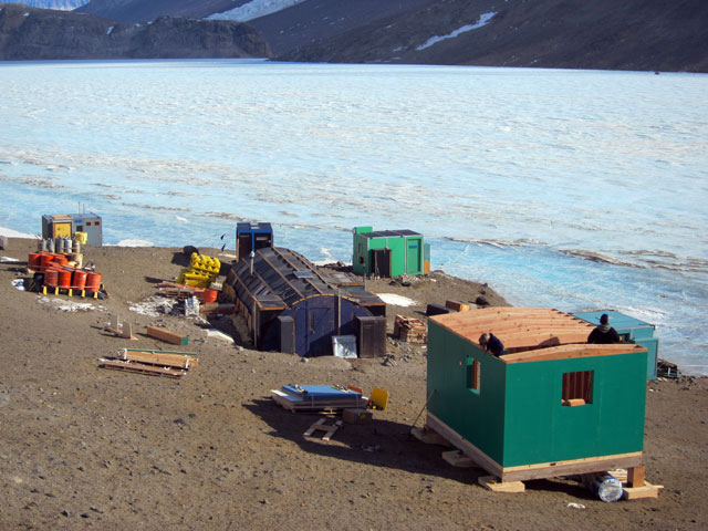 Buildings on the edge of ice-covered lake.