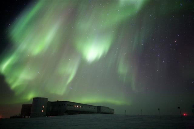Aurora in the night sky above a long building