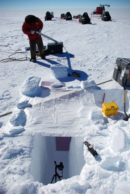 Camera sits in a snow pit.