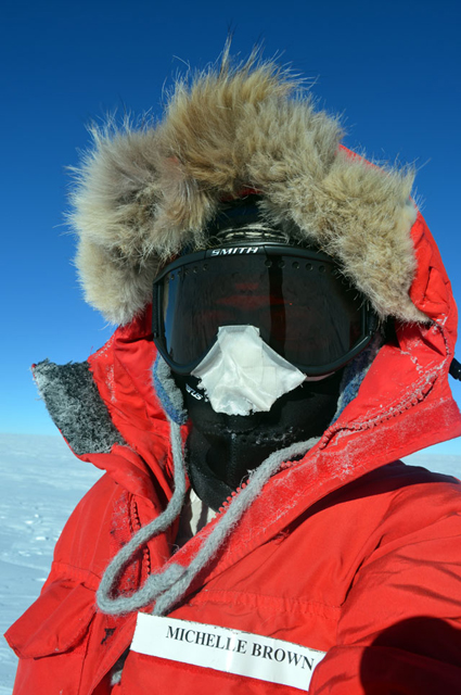 Person wearing parka and goggles.